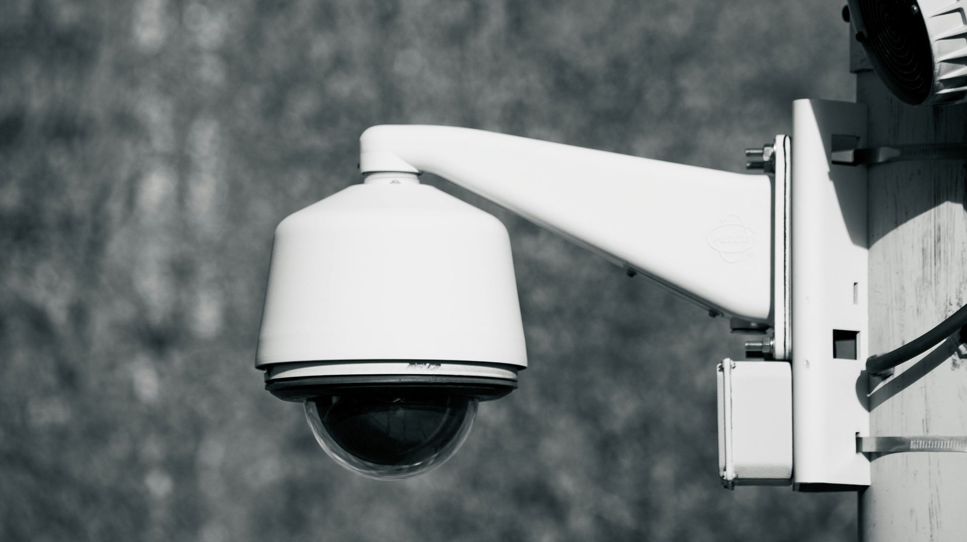 Two bullet-style security cameras professionally mounted on a commercial building wall