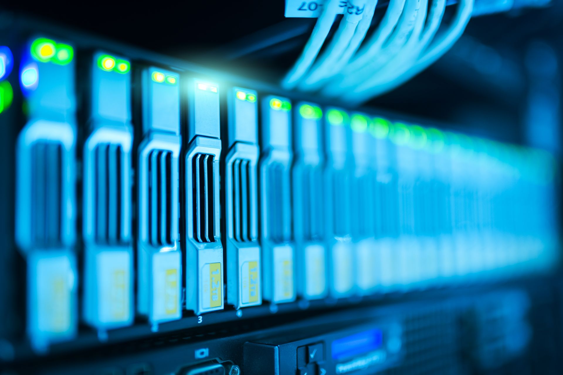 Close view of enterprise storage drive bays with status lights in a server rack